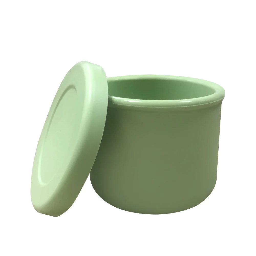 Green storage jar with lid on a white background