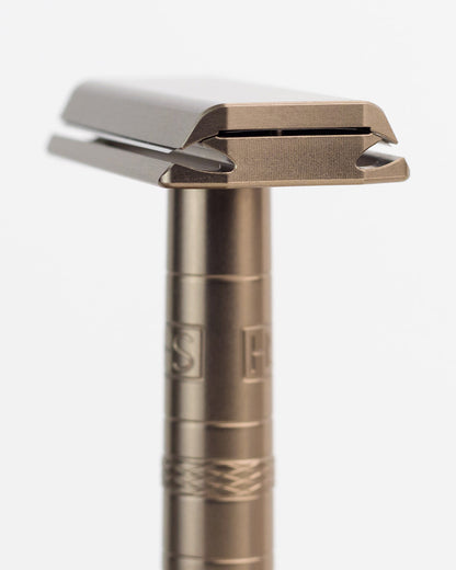 Bronze safety razor on a white background