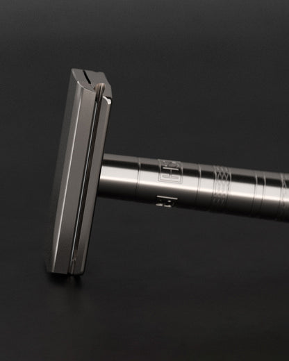Man holding the 63g Henson Ti22 Titanium Razor demonstrating perfect weight balance for gravity-assisted shaving.