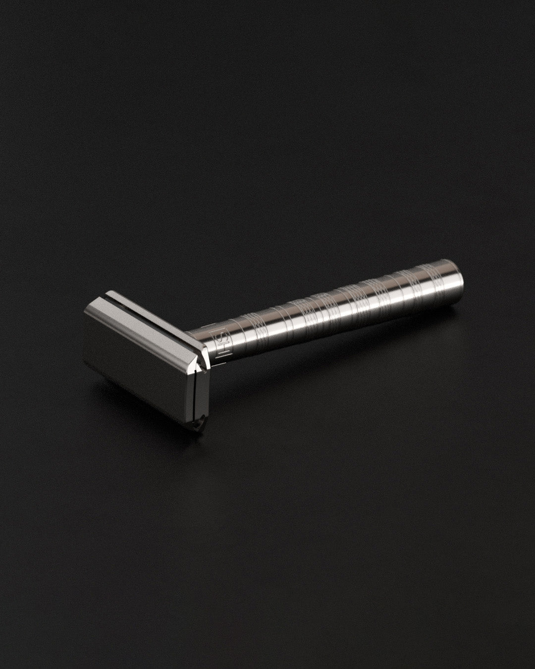 Silver safety razor on a black background